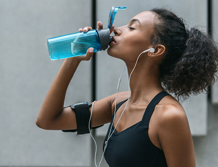 Woman drinking water after a workout