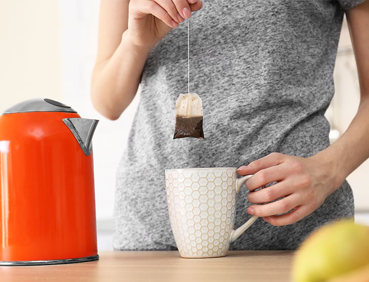 Woman making tea in the morning