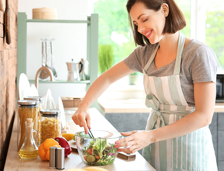 Woman preparing a salad at home