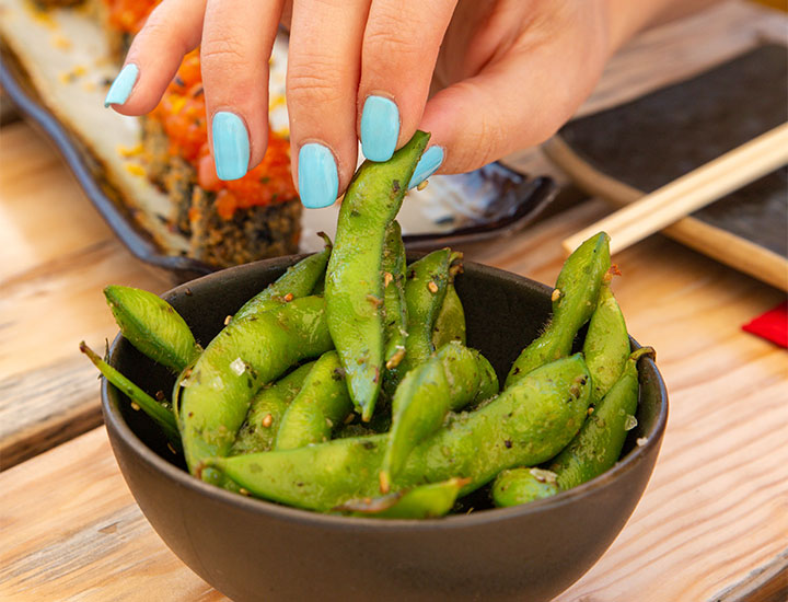 Woman eating edamame