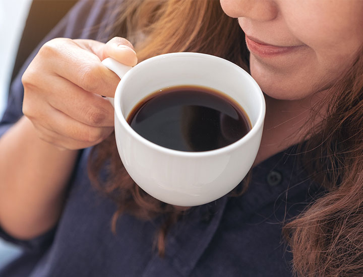 Woman sipping plain black coffee