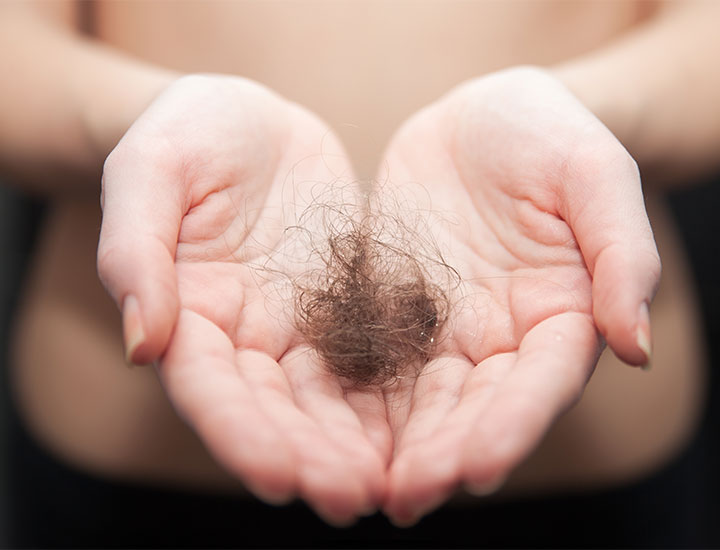 woman-holding-clump-hair