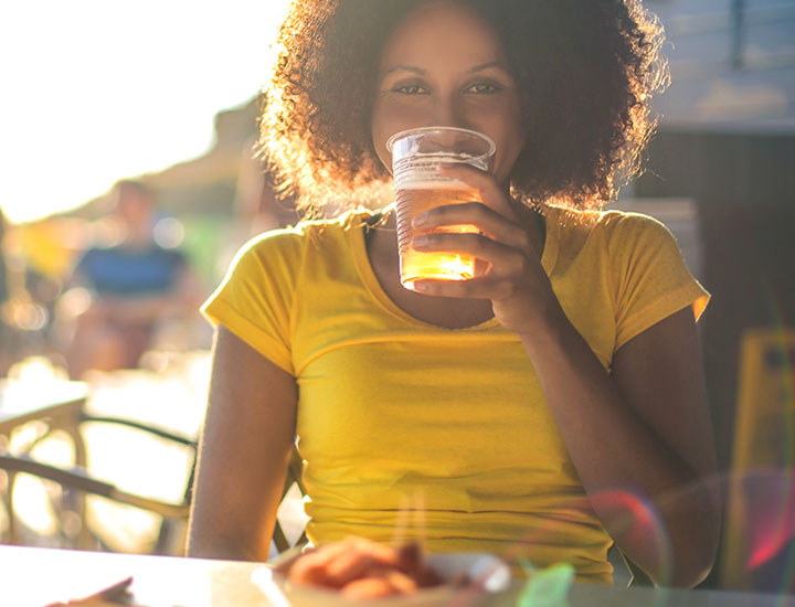 Young woman sipping beer