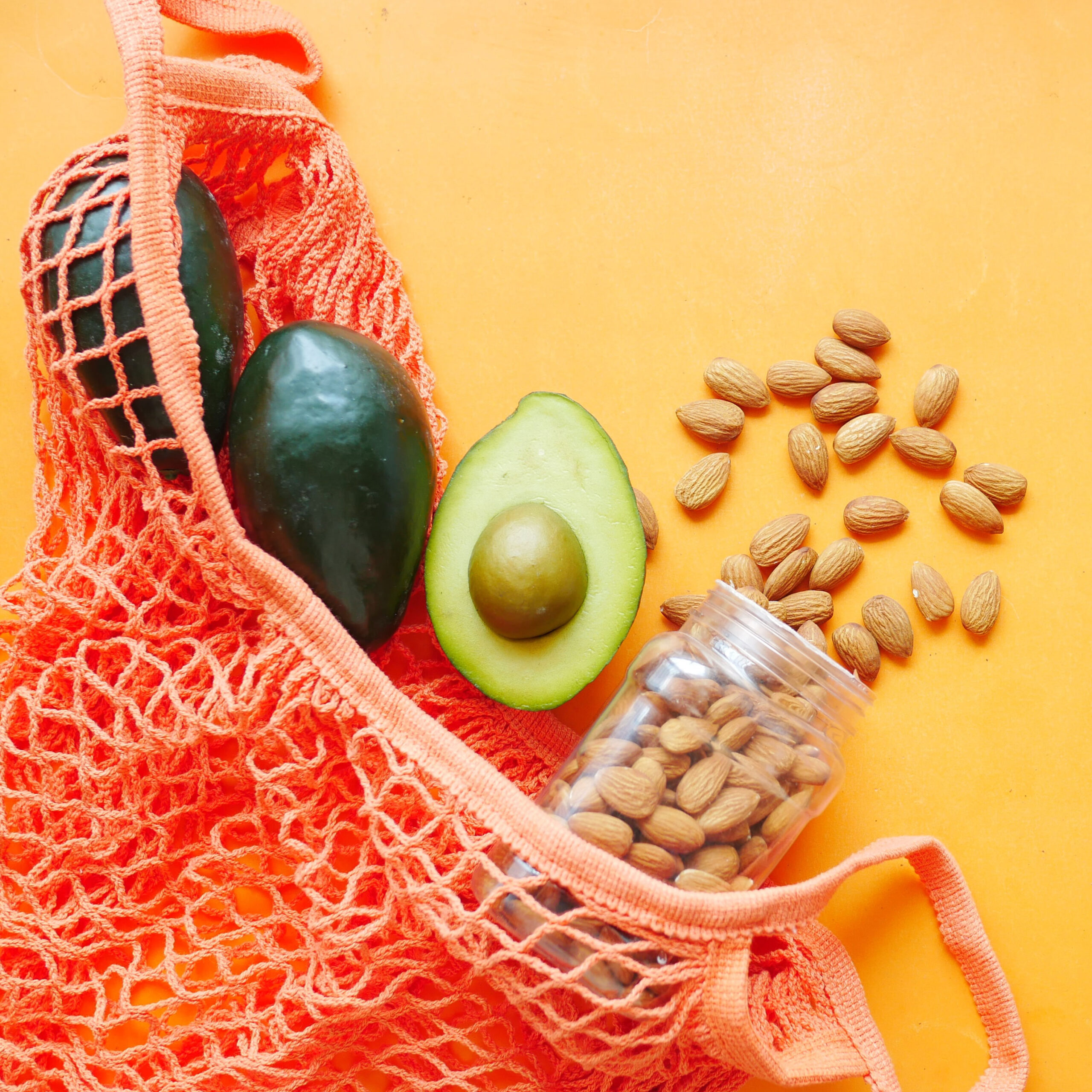 avocado and almonds spilling out of mesh bag