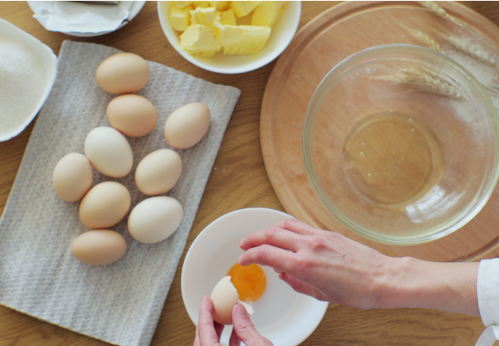 Woman cracking eggs into a bowl