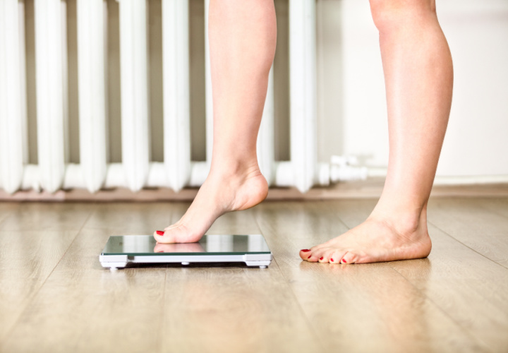 Woman stepping on a scale