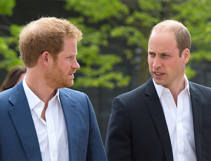 Prince Harry Prince William glancing at each other