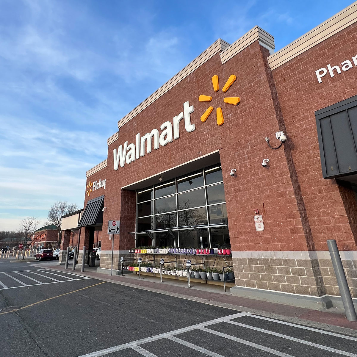 walmart storefront blue sky parking lot brick white lettering