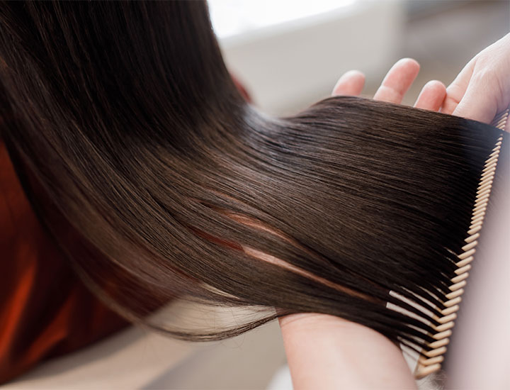 combing-long-healthy-brown-hair