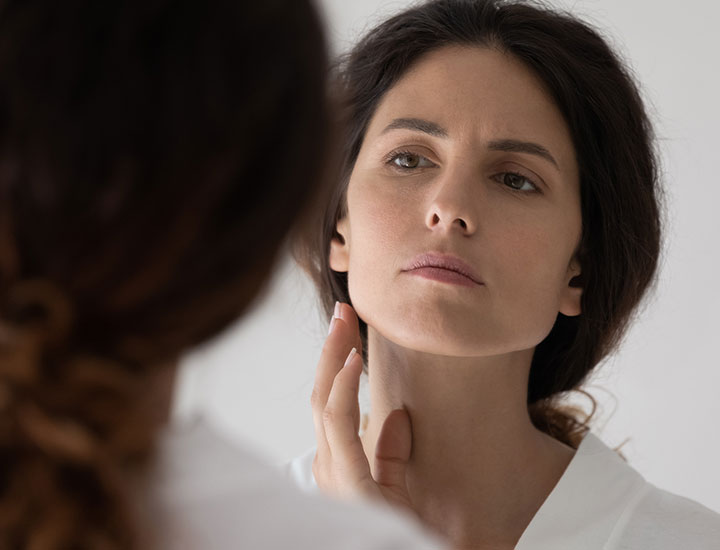 concerned-woman-looking-in-mirror