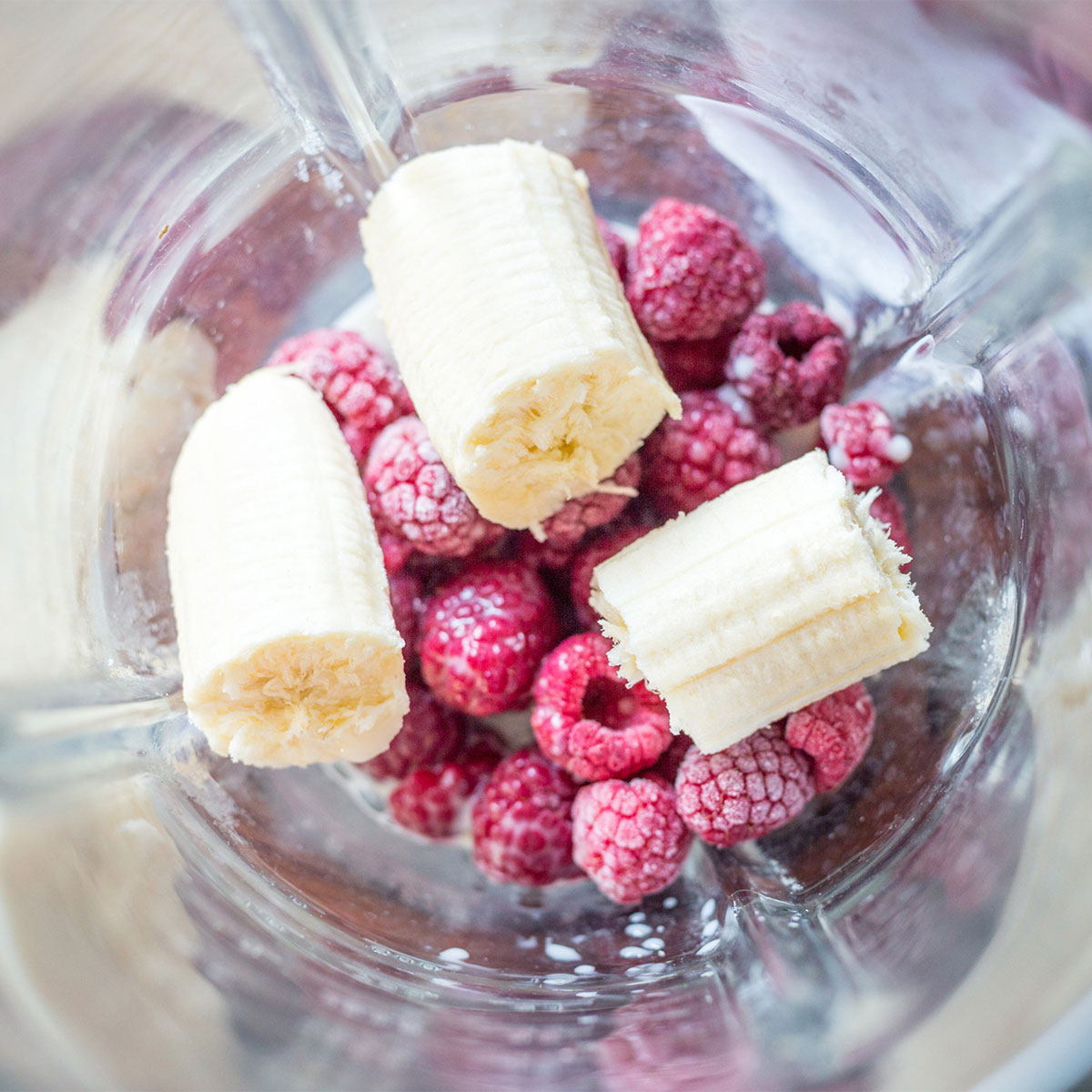 frozen fruit in blender bananas raspberries mixed