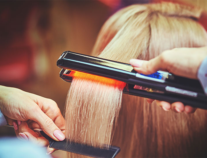 hair-dresser-using-flat-iron