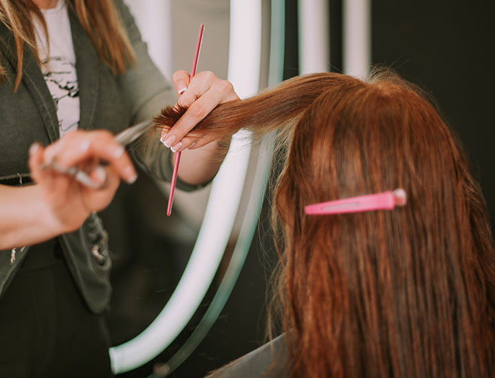 hair-stylist-cutting-redhead