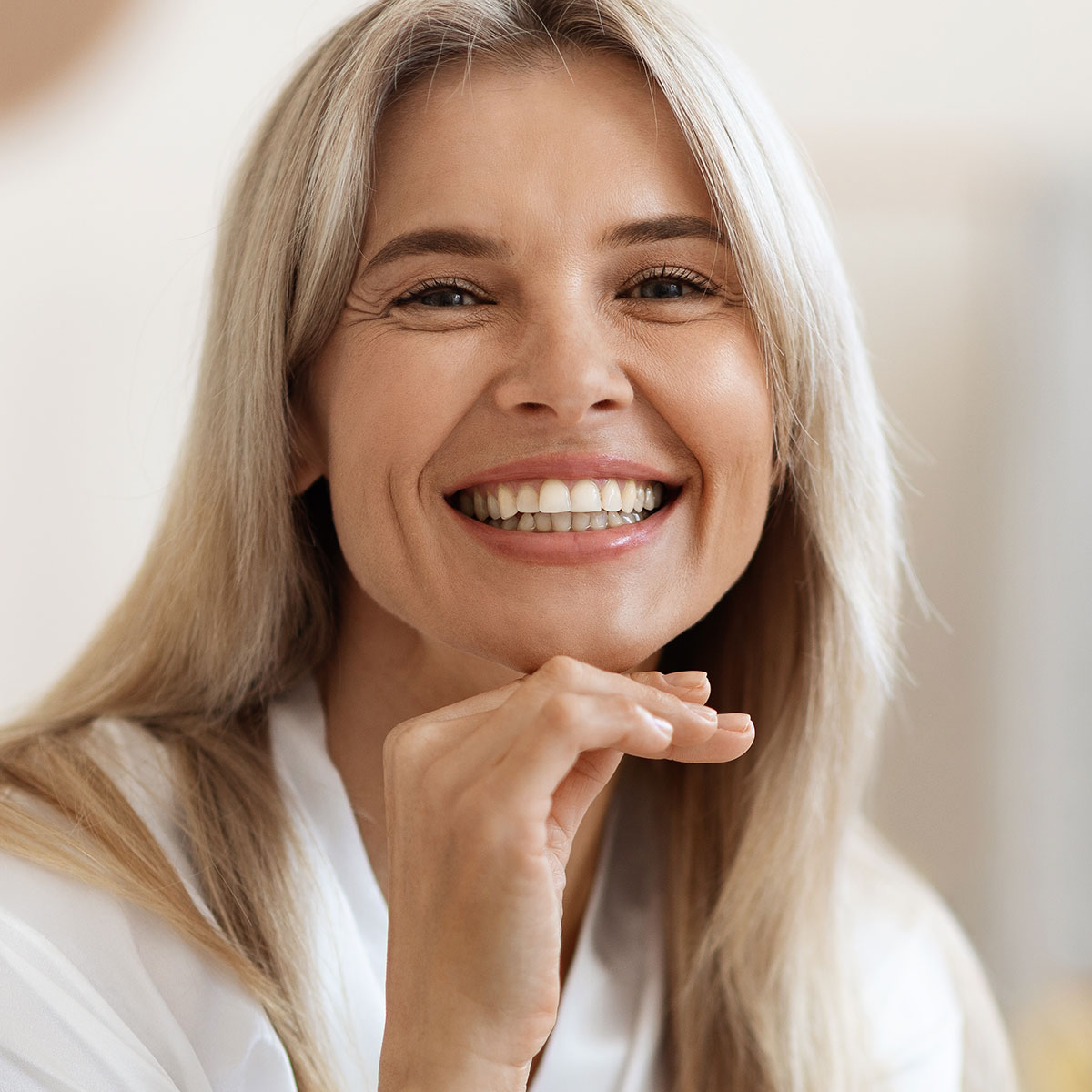 older woman with nice glowing skin smiling