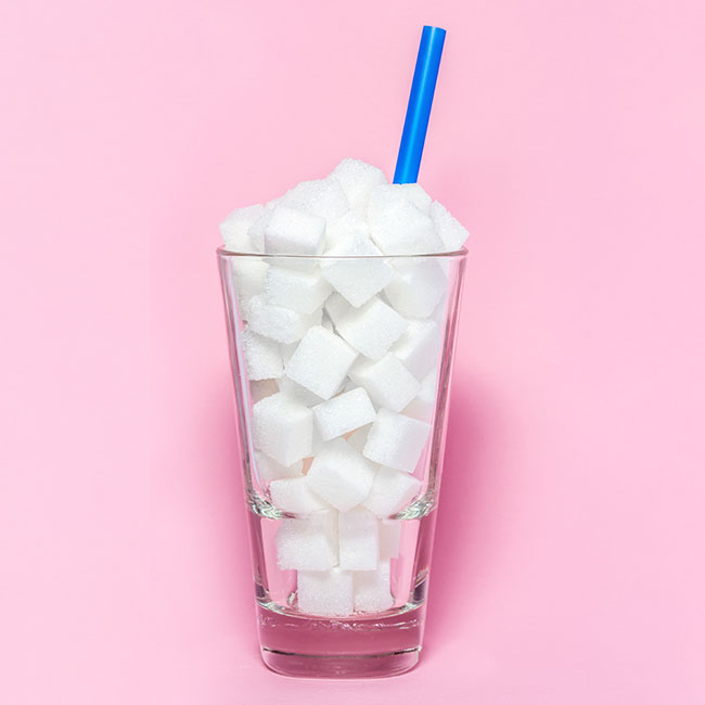 sugar cubes in glass with straw