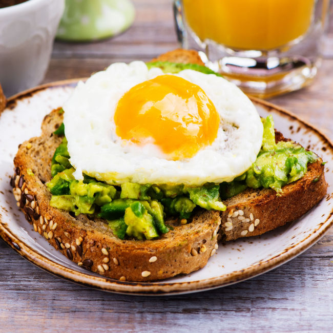 whole grain toast with avocado and an egg