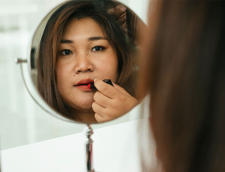 woman-applying-red-lipstick