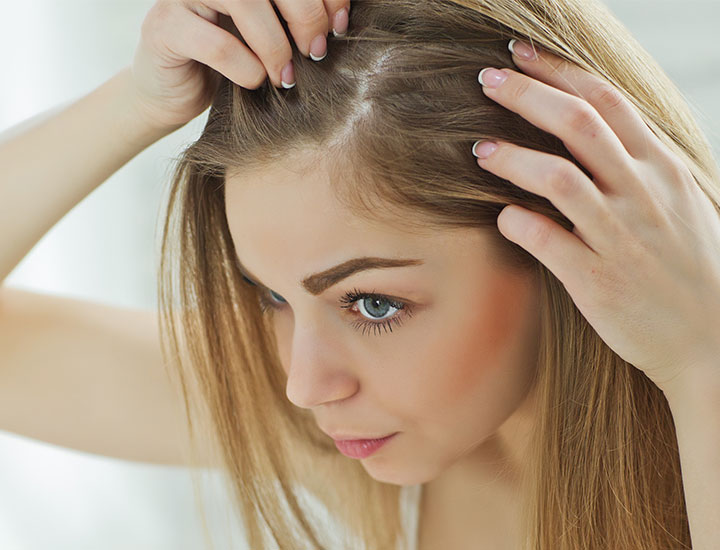 woman-checking-scalp-hair-loss