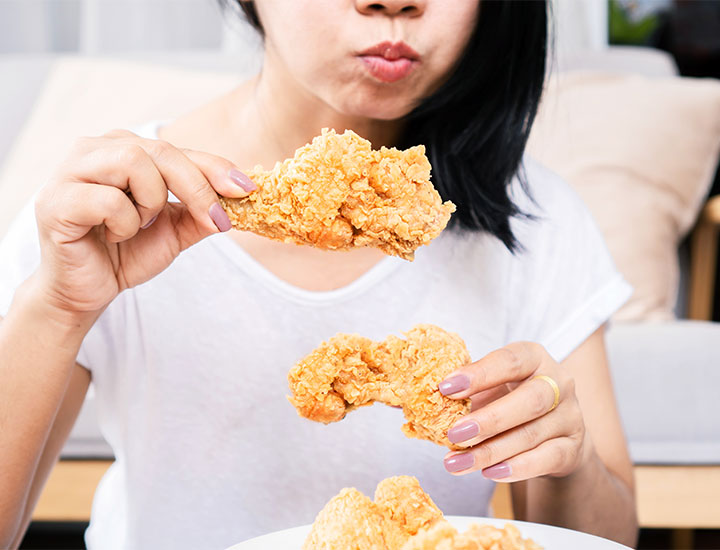 woman eating fried chicken