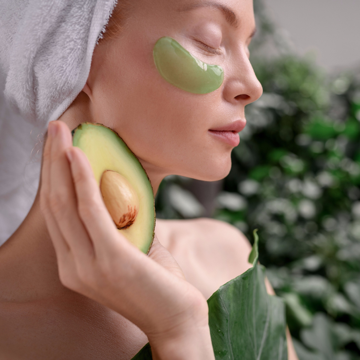 woman holding avocado spa white towel green under-eye gel