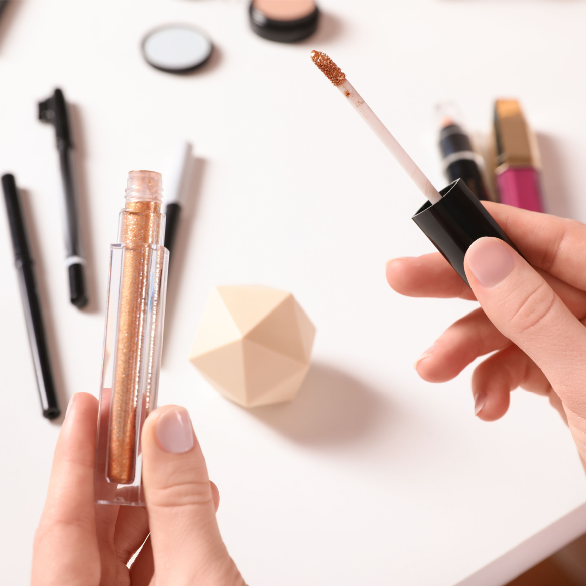 woman holding liquid eyeshadow product