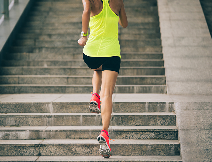 Woman jogging up a staircase