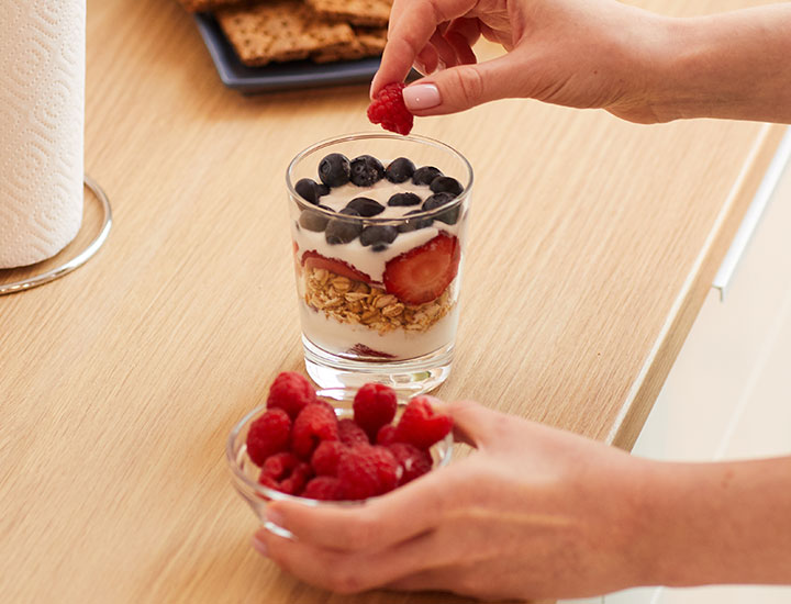 Woman preparing a yogurt parfait