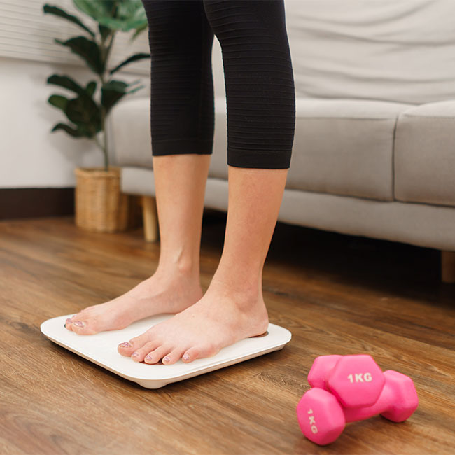 woman standing on scale at home