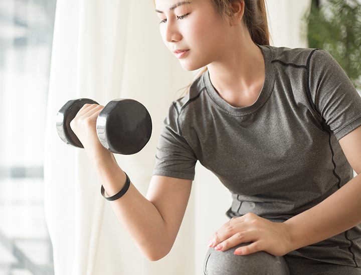 Woman strength training with hand weights