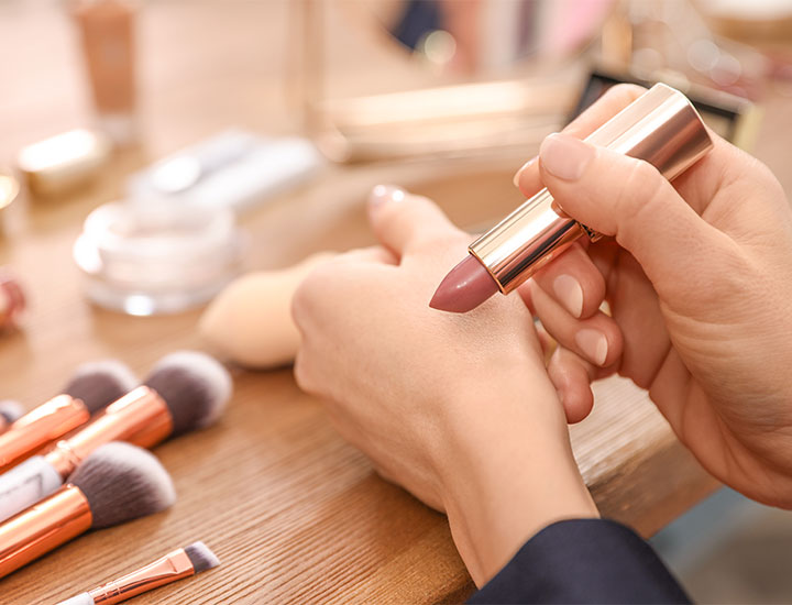 woman-applying-lipstick-hand