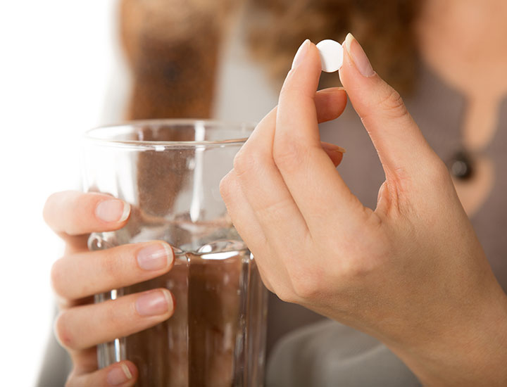 woman-taking-white-supplement