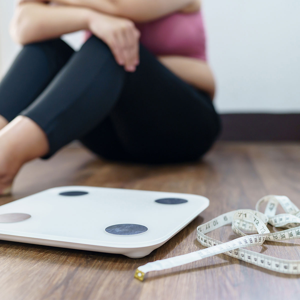 woman upset about weight loss floor corner scale