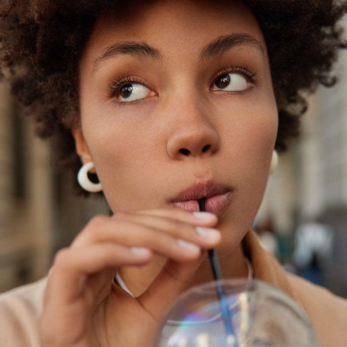 woman-afro-hair-sipping-drink