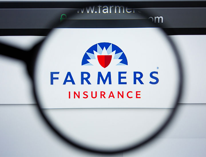 Farmer's Insurance logo under magnifying glass on computer screen