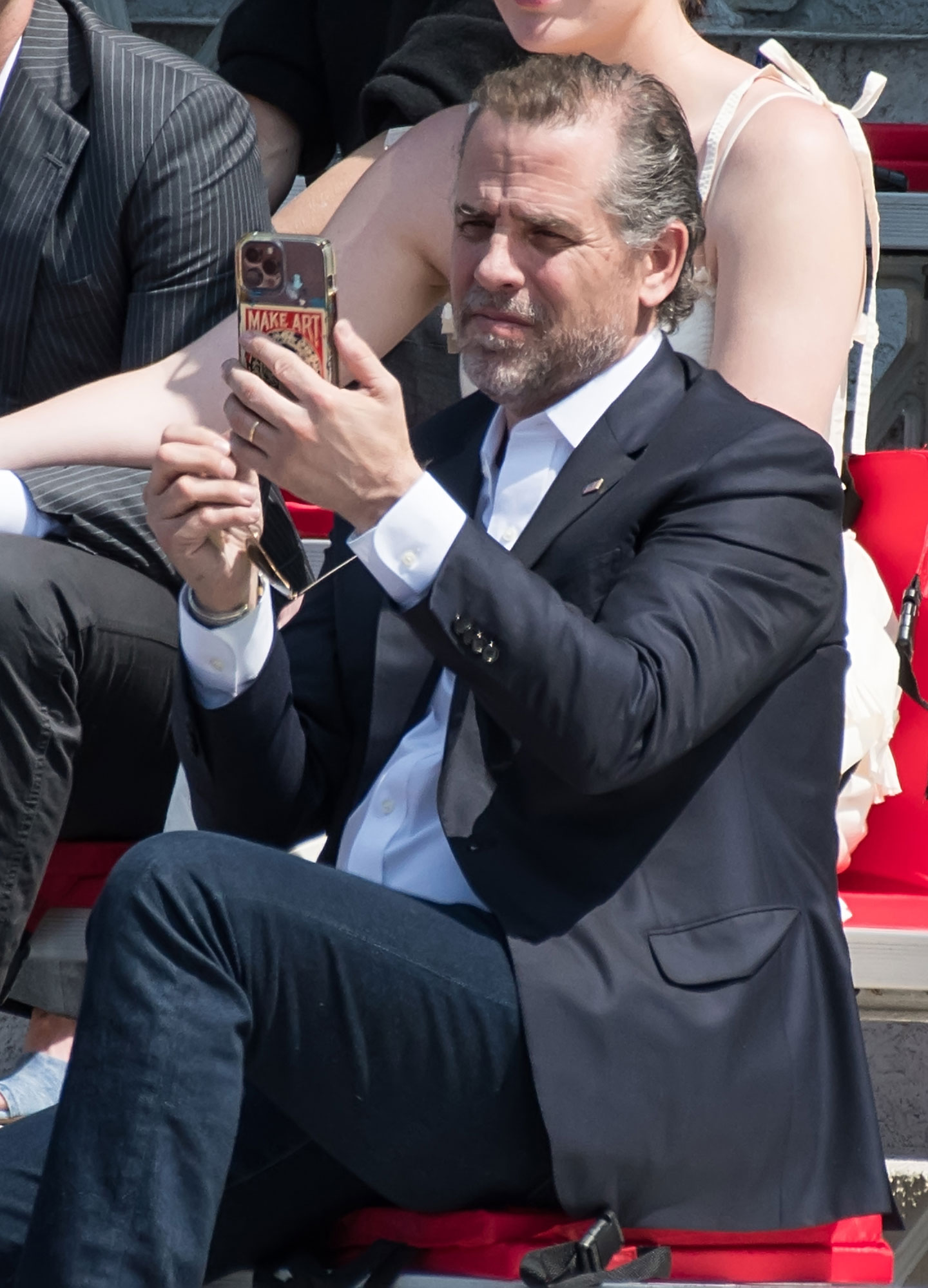 Hunter Biden on phone at graduation