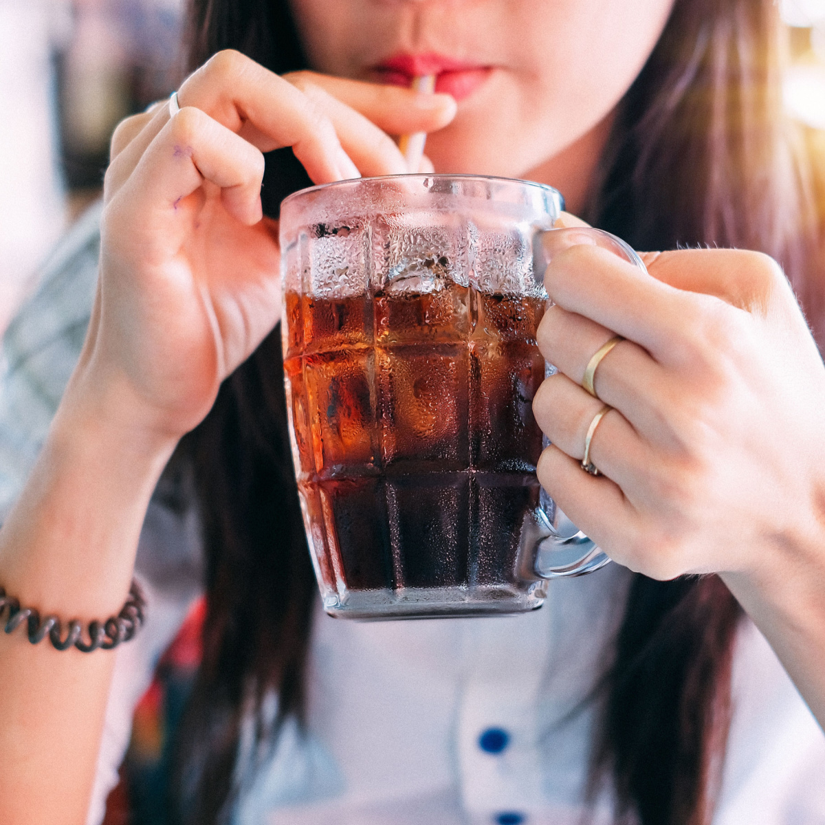 woman sipping on soda