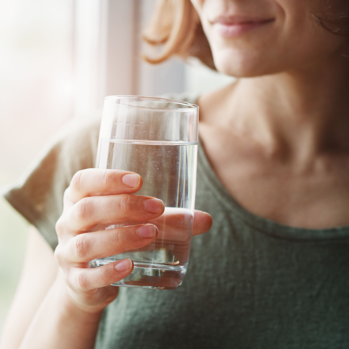 woman holding glass of water