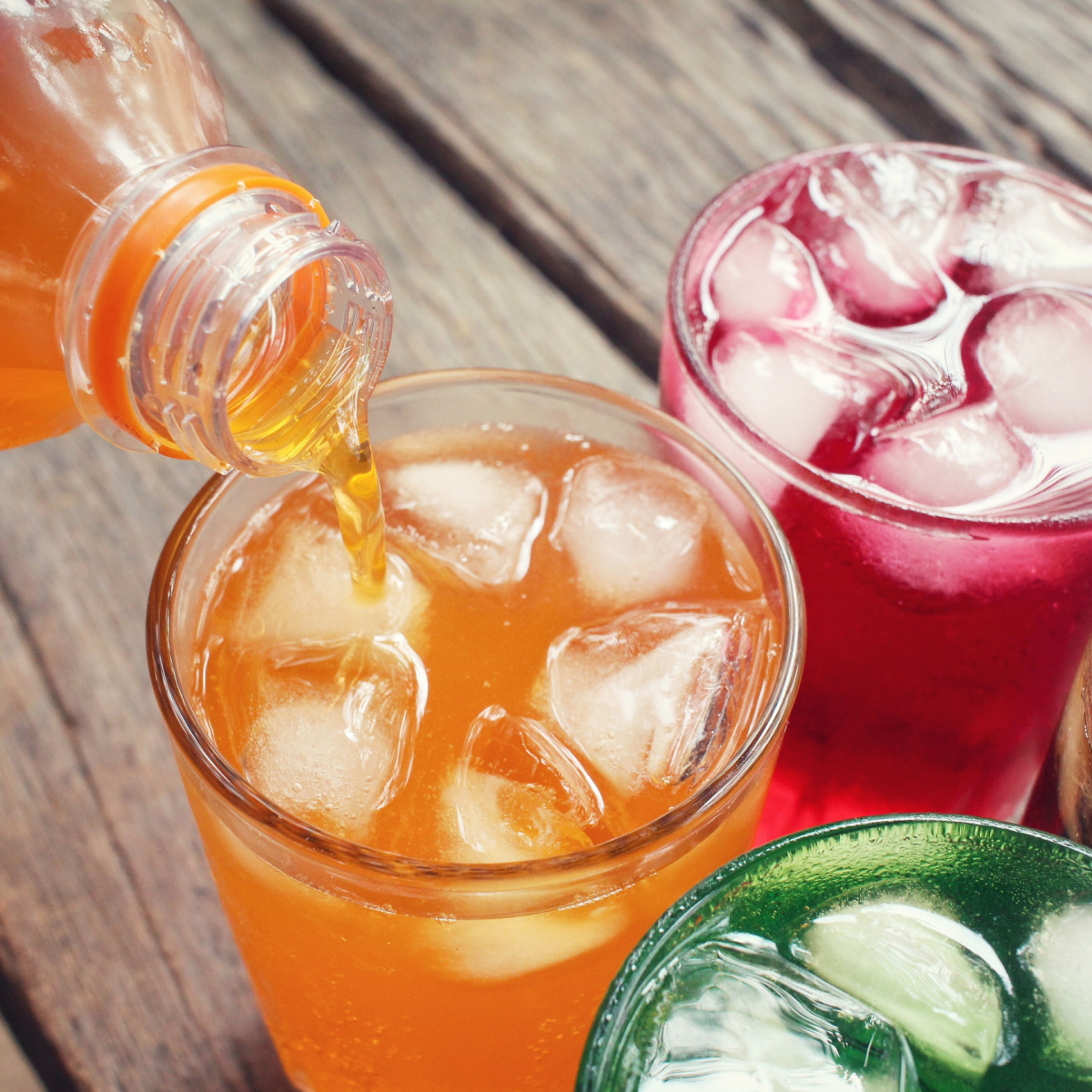 various soft drinks in glass cups