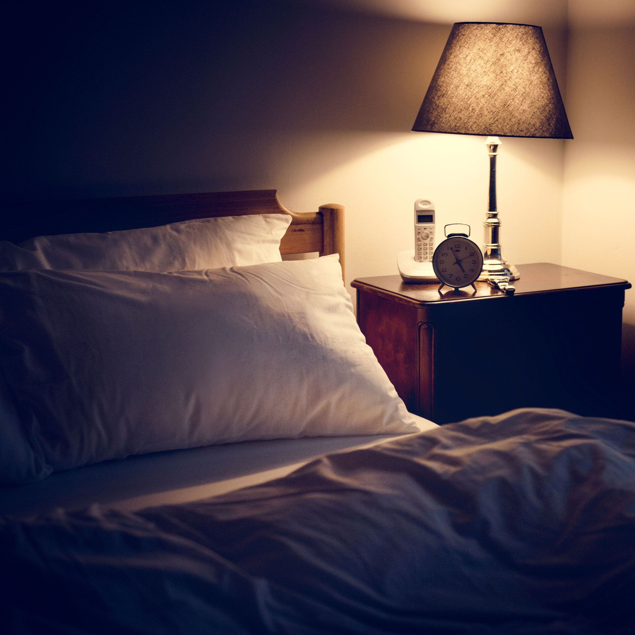 bed with lamp on bedside table