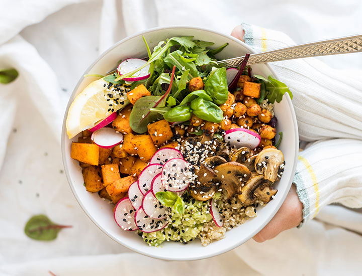 healthy quinoa bowl with vegetables avocado and seeds