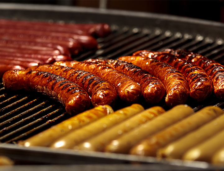 hot dogs and sausages on grill