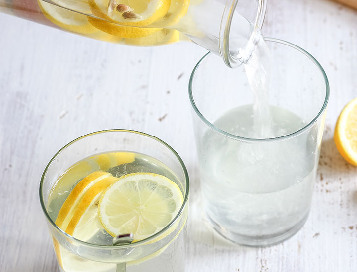 lemon water pouring into glasses