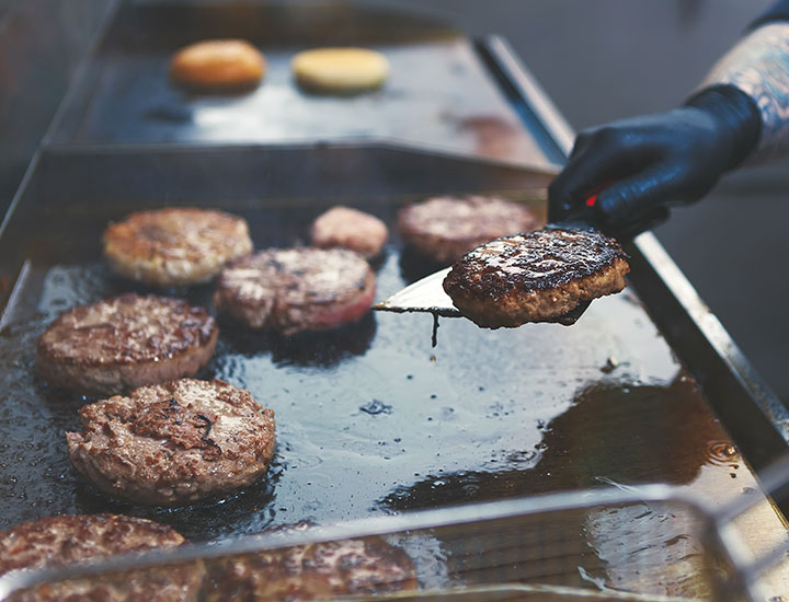 man grilling burgers at a restaurant