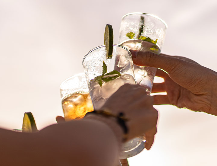 people cheering with cocktails