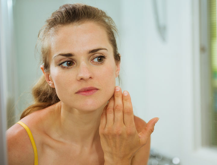 woman-checking-skin-mirror