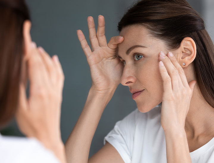 woman-checks-skin-mirror