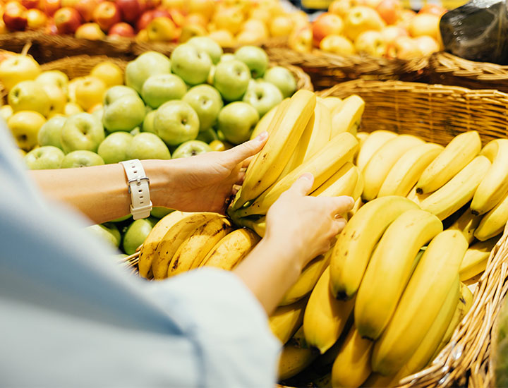 woman shopping for bananas