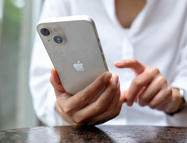 woman-tapping-white-iphone