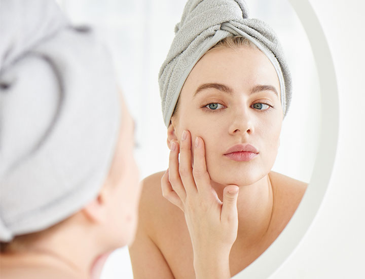 woman-looking-at-skin-mirror