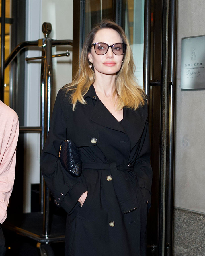 angelina jolie looks classy in a long black coat as she goes